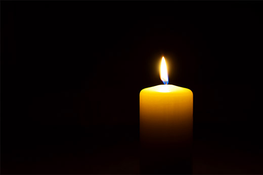 candle lit against a black background